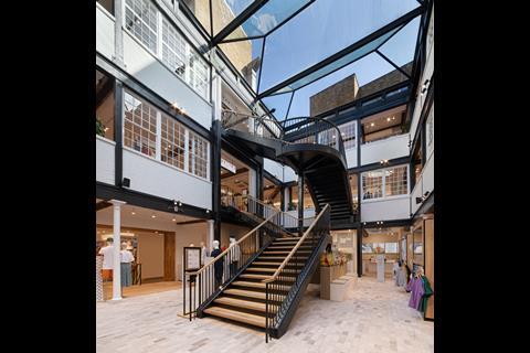 Interior of Uniqlo Covent Garden store showing staircase and products
